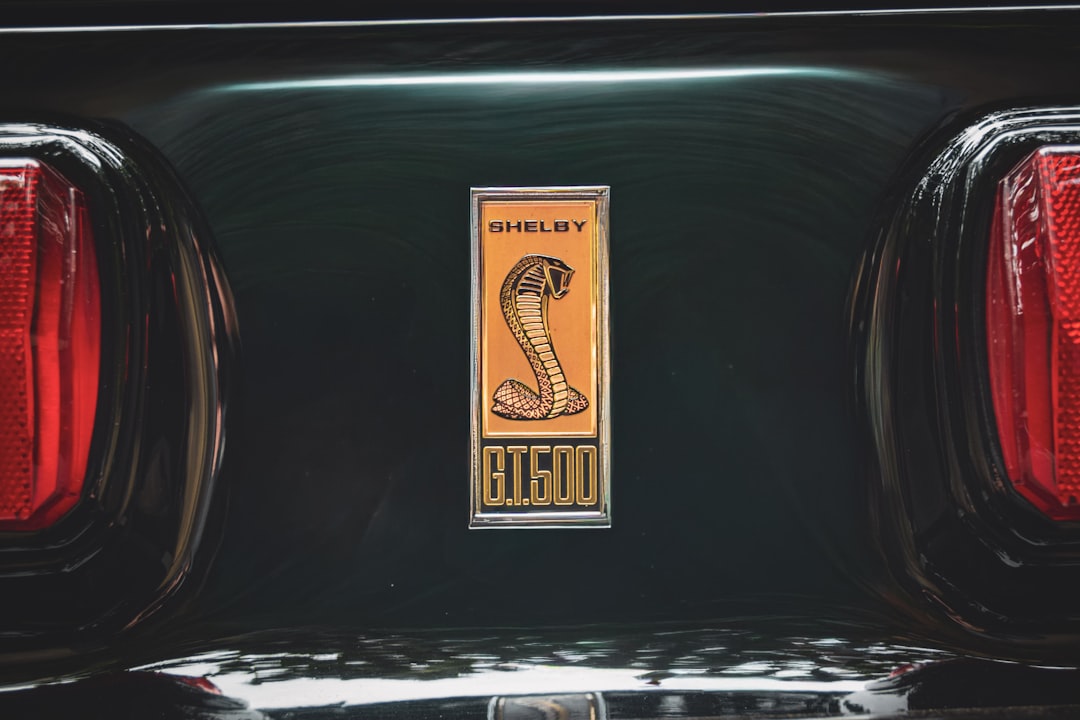 Shelby cobra emblem on a dark green car
