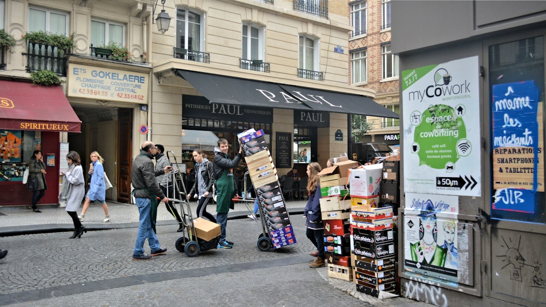 man in black jacket and black pants pushing black and gray stroller