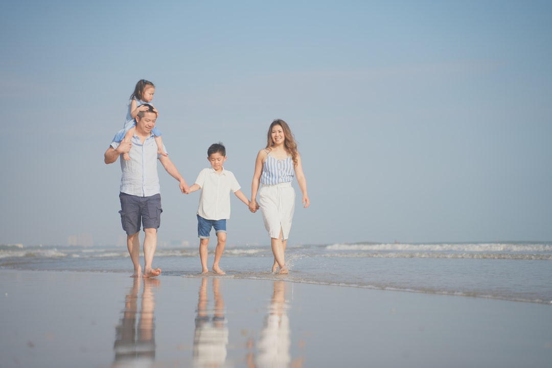 a group of people walking on a beach