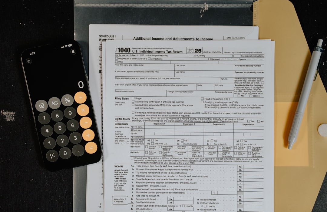 Tax forms and calculator on a desk.