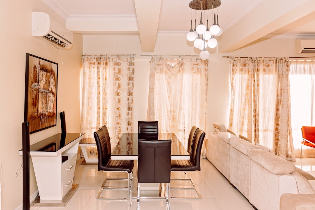 a living room with a couch, table, chairs and a television