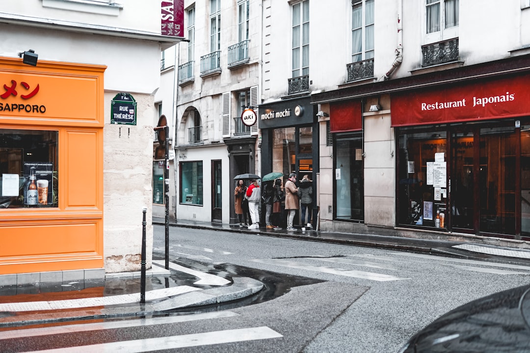 people walking on sidewalk near building during daytime