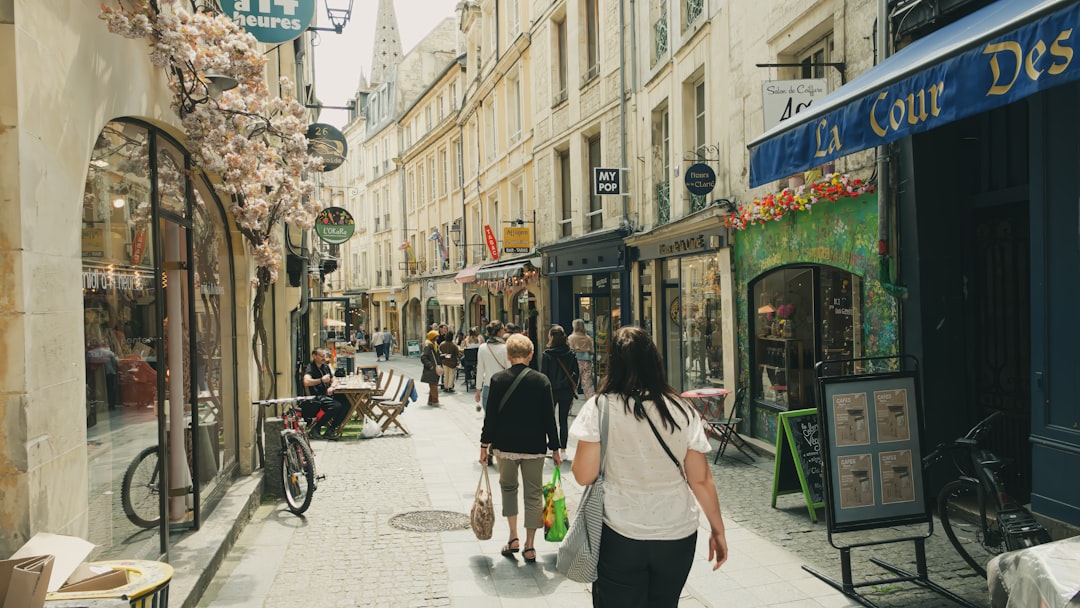 A couple of people that are walking down a street