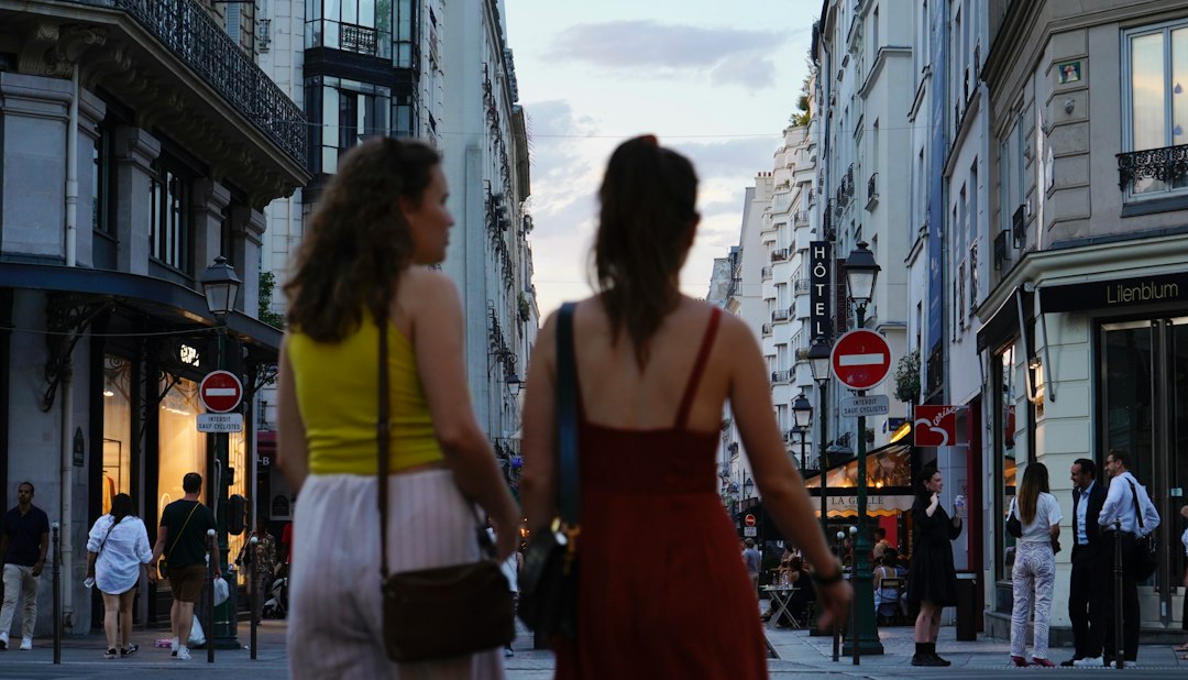 a couple of women walking down a street